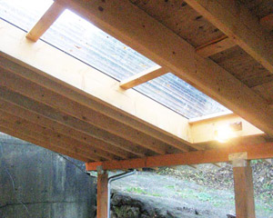 Another way to bring in light: a polycarbonate roof panel that integrates seamlessly into the metal roofing.  This element is both in the shop and the carport roof