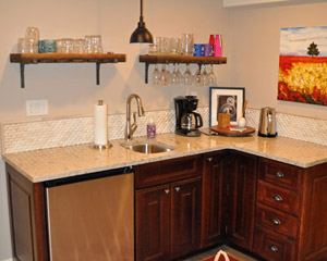 wet bar with quartz counters and tile backsplash