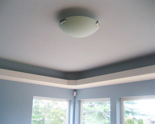 The living room has a light cove that conceals ductwork on one side