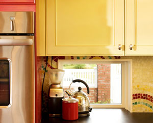 At the framing stage, this corner of the kitchen looked too dark.  The solution: a small peekaboo window at counter level that brings in light