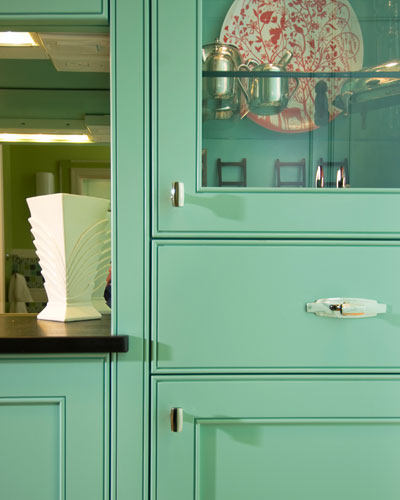 This cabinet-filled hall provides access to the kitchen from the living room, and tons of storage.  The coffered ceiling makes it feel like its own room