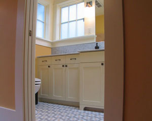 The star of this project is the bathroom, with furniture-style custom cabinetry