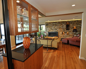 By removing it and selecting a living room wall as the location for a new gas fireplace, the floor plan is now open.  Throughout, the short-length red oak flooring was replaced with larger-format quarter sawn white oak flooring with no stain.  It's a subtle but amazing change