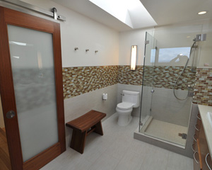 The Nyatoh door installed barn door-style reinforces the contemporary look, while subtle robe hooks to the right provide function