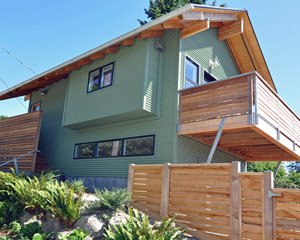 The entry to the studio is a mix of corrugated metal and Cumaru siding.  Fencing helps maintain privacy