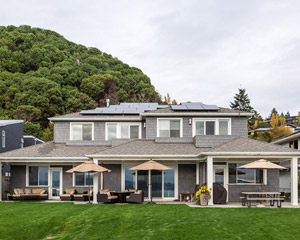 From the water, the solar panels are visible but low-key, and landscaping installed entirely by the owners shows off beautifully