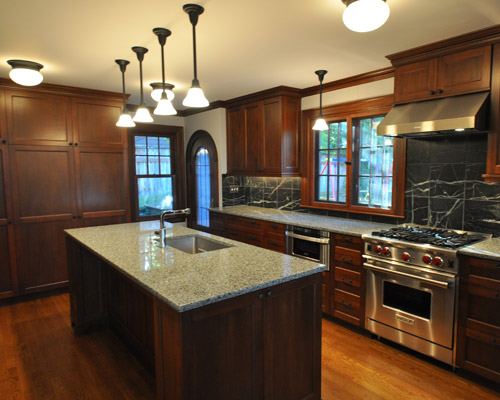 The area behind the old stove was a full bath. By removing that, new cabinets are closer to the rear wall, opening up additional floor space for a full wall of pantry cabinets