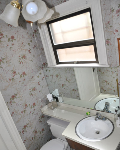 More '70s detailing goes by the wayside as this full bath shrinks in size