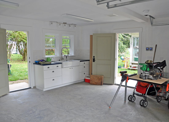 Inside the garage, there is ample space for two cars, plus a dedicated area for shop work and other projects, including a work sink area perfect for home brewing.  The opposite wall is home to all the mechanical equipment, including the tankless hot water heater, which provides both domestic hot water and heated water for the radiant heating in floor.  There is also an electric car charging station and an easy-to-use slot for a generator if needed