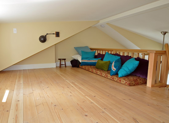 Upstairs, the bonus space in the loft can be used for a variety of purposes.  The windows, carefully chosen lighting and high ceilings make it an inviting space