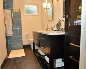 After: A spacious bath and closet with enough room for a furniture storage piece at the entry