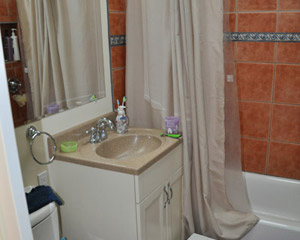 The location of the original door dictated the design, leaving extra space to the left, and not enough space to the right.  Even the pocket door did little to improve the cramped feel