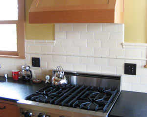 Everything in this kitchen is chosen for efficiency and compactness.  The gas stove is small but very functional.  Custom fir cabinets are used to clad everything, including the exhaust hood