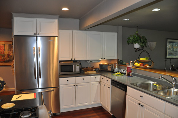 The existing cabinets were painted white and poorly executed, with odd spacing and no connection to the other architectural elements in the house.  Making matters worse, it was only a door opening away from beautifully detailed cabinets in anigre, part of an earlier fireplace remodel