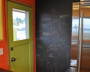 Chalkboard paint makes this easy, and the wall has a bonus too: a magnet board. With stainless appliances, there was nowhere to hang magnets.  This solves that problem stylishly